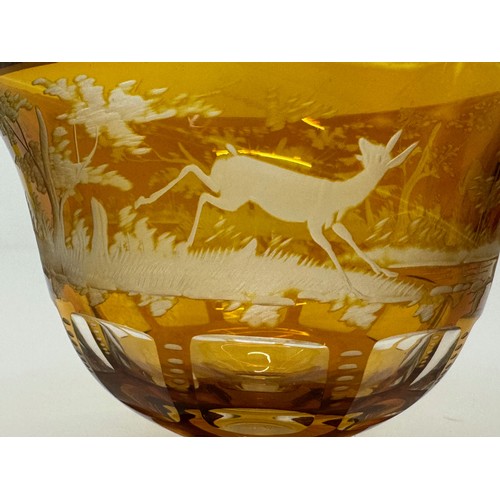 193 - Wheel cut amber glass bowl decorated with deer in a woodland setting, 13 cm diameter x 10.5 cm high.... 