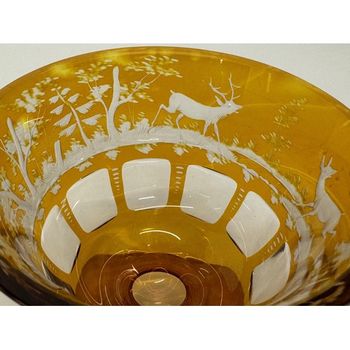 193 - Wheel cut amber glass bowl decorated with deer in a woodland setting, 13 cm diameter x 10.5 cm high.... 