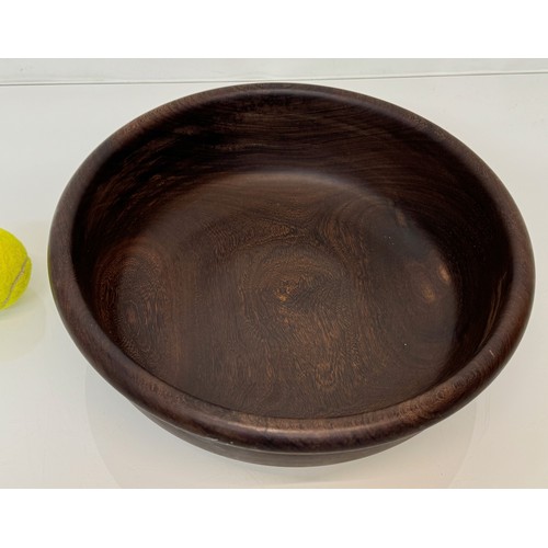 196 - A turned wooden bowl from African hard wood, 34 cm x 10 cm high.

This lot is available for in-house... 