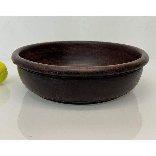 196 - A turned wooden bowl from African hard wood, 34 cm x 10 cm high.

This lot is available for in-house... 