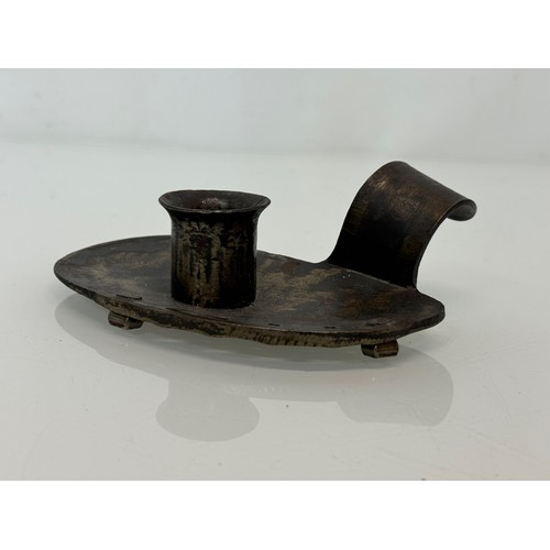 213 - A contemporary wrought iron candle stand, 14 cm long x 4 .5 cm high, marked AP.

This lot is availab... 