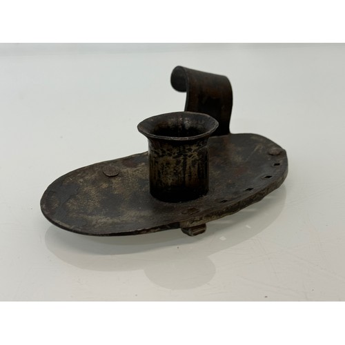 213 - A contemporary wrought iron candle stand, 14 cm long x 4 .5 cm high, marked AP.

This lot is availab... 