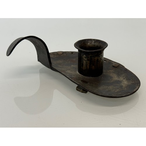 213 - A contemporary wrought iron candle stand, 14 cm long x 4 .5 cm high, marked AP.

This lot is availab... 