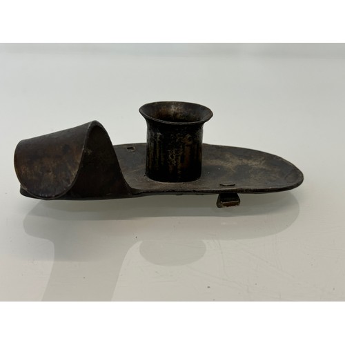 213 - A contemporary wrought iron candle stand, 14 cm long x 4 .5 cm high, marked AP.

This lot is availab... 