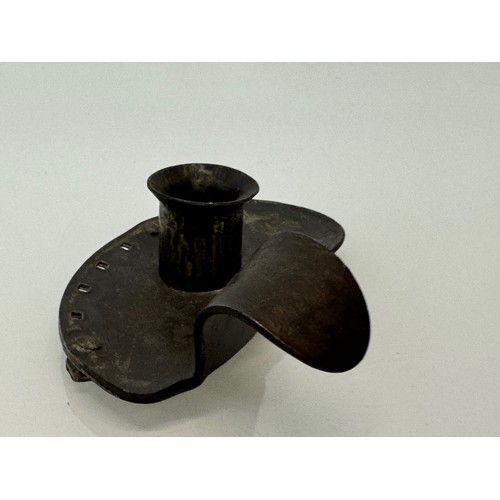 213 - A contemporary wrought iron candle stand, 14 cm long x 4 .5 cm high, marked AP.

This lot is availab... 