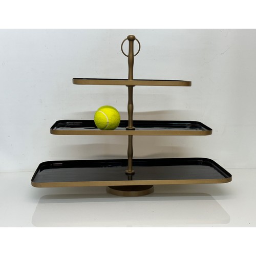 214 - Three tier painted metal display stand, 50 cm x 22 cm and the bottom, 41 cm high.

This lot is avail... 