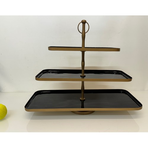 214 - Three tier painted metal display stand, 50 cm x 22 cm and the bottom, 41 cm high.

This lot is avail... 