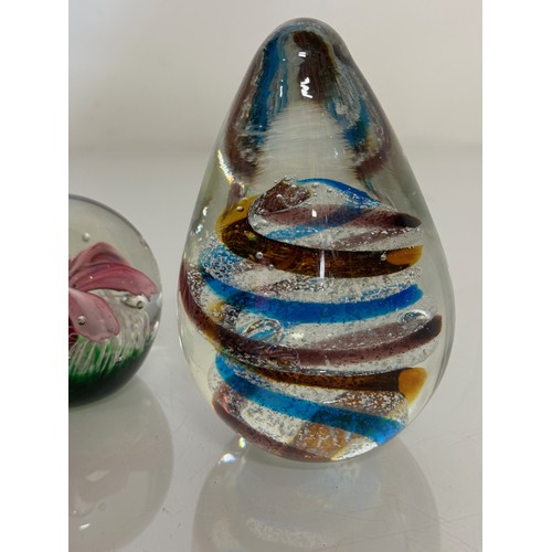 216 - Three decorative glass paperweights. 13 cm 7 cm and 6 cm high.

This lot is available for in-house s... 