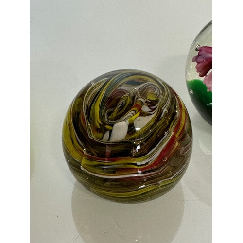 216 - Three decorative glass paperweights. 13 cm 7 cm and 6 cm high.

This lot is available for in-house s... 