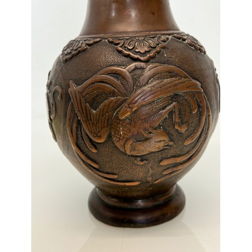 187 - Oriental copper vase with embossed decoration of birds and leaves, 32 cm tall x 18 cm in diameter.

... 