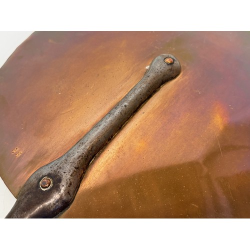 20 - Kitchenalia, large copper pan lid with a wrought iron handle, 35 cm diameter x 63 cm long.

This lot... 