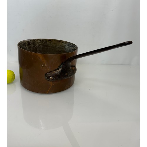 15 - Kitchenalia, a large  and very weighty copper saucepan, 28 cm in diameter x 20 cm deep and 58 cm lon... 