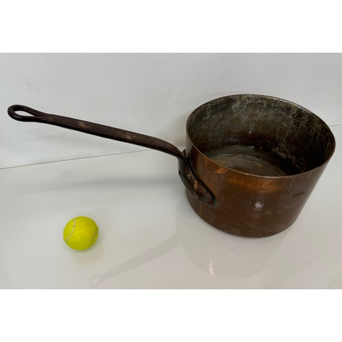 15 - Kitchenalia, a large  and very weighty copper saucepan, 28 cm in diameter x 20 cm deep and 58 cm lon... 