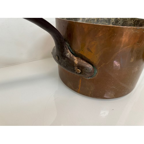 15 - Kitchenalia, a large  and very weighty copper saucepan, 28 cm in diameter x 20 cm deep and 58 cm lon... 