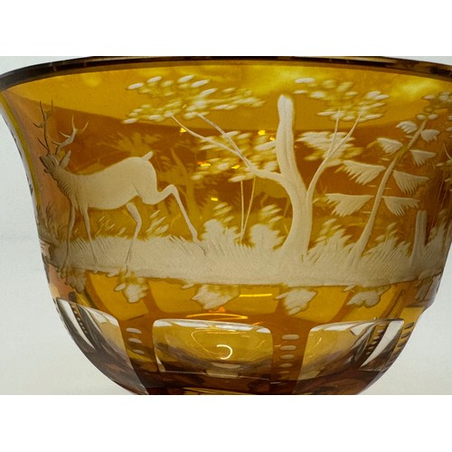 229 - Wheel cut amber glass bowl decorated with deer in a woodland setting, 13 cm diameter x 10.5 cm high.... 