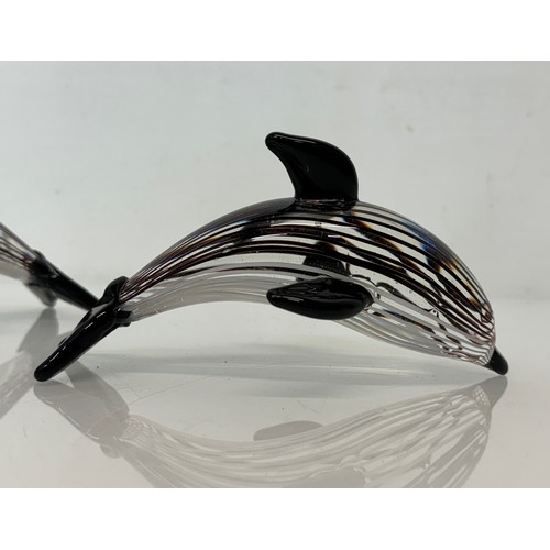 243 - Pair of mid century glass dolphins, each 17 cm long.

This lot is available for in-house shipping