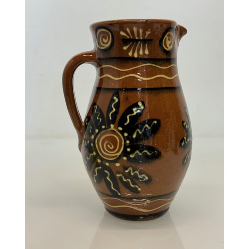 245 - A slip decorated stoneware jug, unmarked studio pottery, 23 cm high.

This lot is available for in-h... 