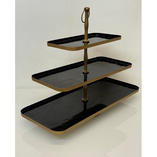 249 - Three tier painted metal display stand, 50 cm x 22 cm and the bottom, 41 cm high.

This lot is avail... 