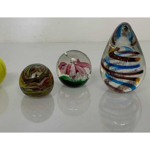 251 - Three decorative glass paperweights. 13 cm 7 cm and 6 cm high.

This lot is available for in-house s... 