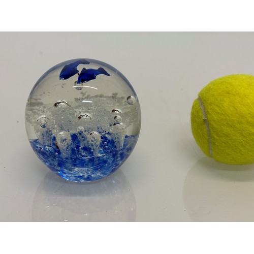 38 - A glass paperweight with blue fish set agains an oxigenated backdrop, 8 cm tall.

This lot is availa... 