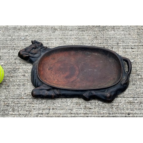 95 - Cast iron dish fitted within the centre of a seated cow form, 32 cm x 22cm 

This lot is available f... 