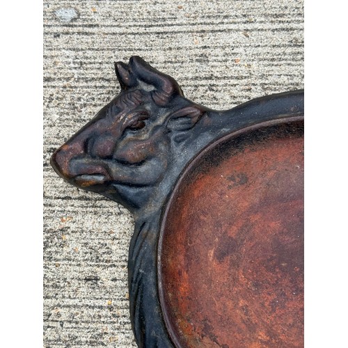 95 - Cast iron dish fitted within the centre of a seated cow form, 32 cm x 22cm 

This lot is available f... 