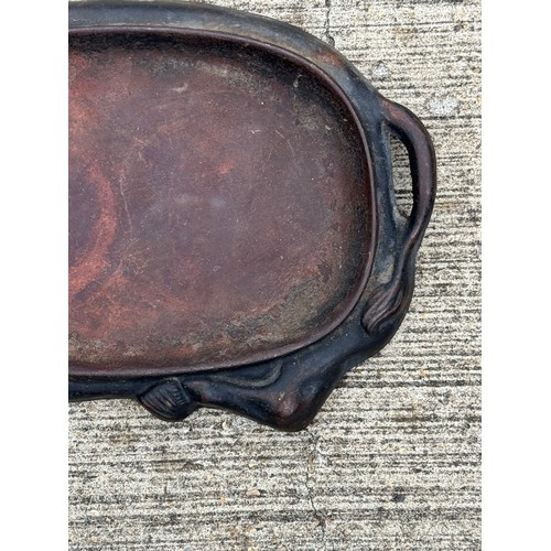 95 - Cast iron dish fitted within the centre of a seated cow form, 32 cm x 22cm 

This lot is available f... 