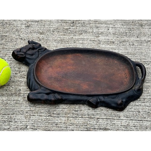 96 - Cast iron dish fitted within the centre of a seated cow form, 32 cm x 22cm 

This lot is available f... 