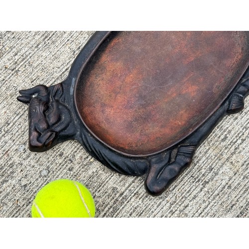 96 - Cast iron dish fitted within the centre of a seated cow form, 32 cm x 22cm 

This lot is available f... 