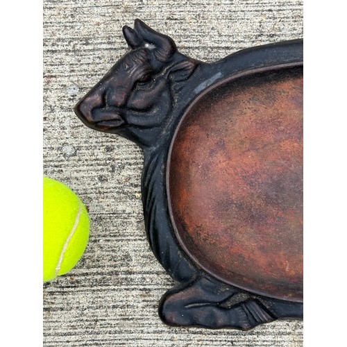 96 - Cast iron dish fitted within the centre of a seated cow form, 32 cm x 22cm 

This lot is available f... 