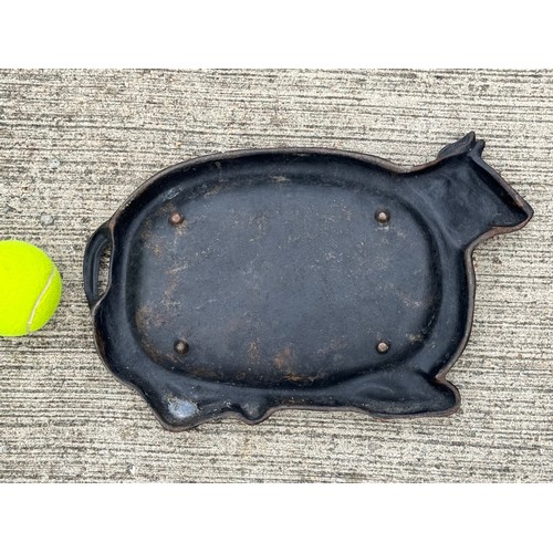 96 - Cast iron dish fitted within the centre of a seated cow form, 32 cm x 22cm 

This lot is available f... 