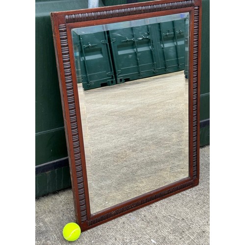 100 - Edwardian bevel edged wall mirror in a decorative wooden frame, 61 cm x 81 cm.

This lot is collecti... 