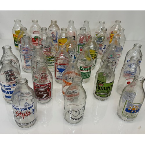 164 - A collection of advertising themed glass milk bottles.

This lot is available for in-house shipping