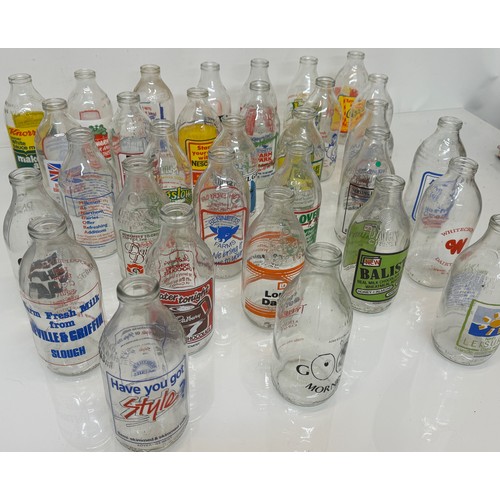 164 - A collection of advertising themed glass milk bottles.

This lot is available for in-house shipping