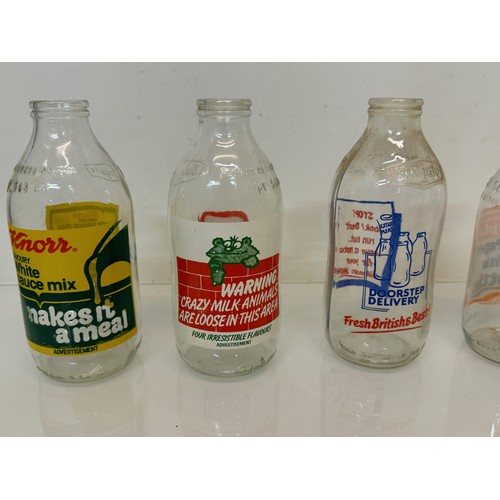 164 - A collection of advertising themed glass milk bottles.

This lot is available for in-house shipping