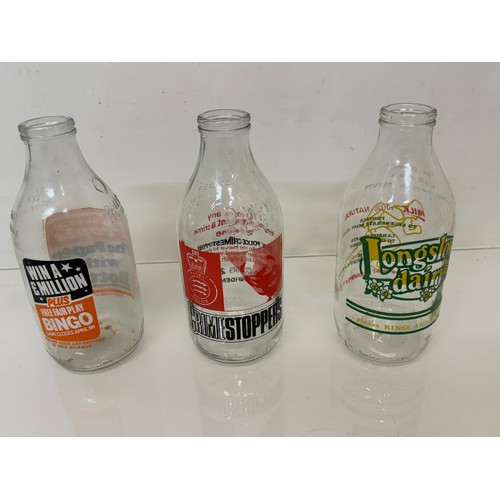 164 - A collection of advertising themed glass milk bottles.

This lot is available for in-house shipping