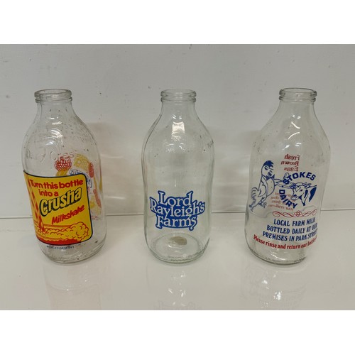 164 - A collection of advertising themed glass milk bottles.

This lot is available for in-house shipping