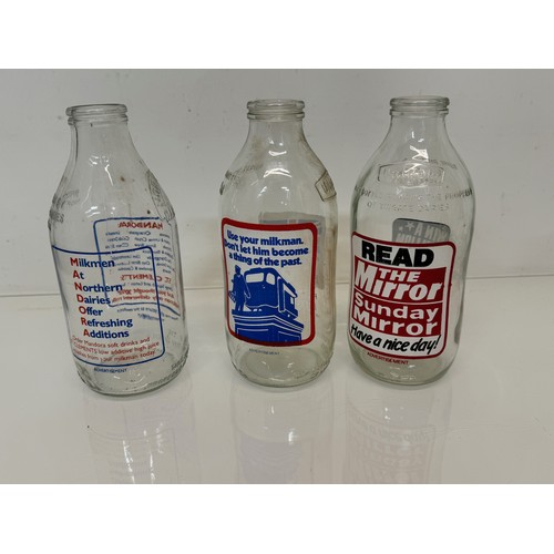 164 - A collection of advertising themed glass milk bottles.

This lot is available for in-house shipping