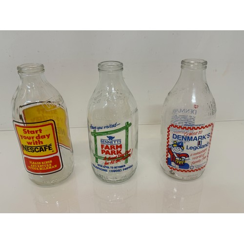 164 - A collection of advertising themed glass milk bottles.

This lot is available for in-house shipping