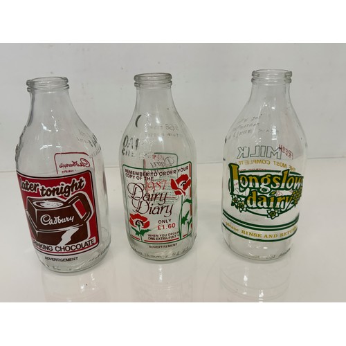 164 - A collection of advertising themed glass milk bottles.

This lot is available for in-house shipping