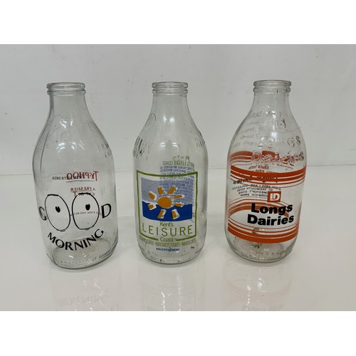 164 - A collection of advertising themed glass milk bottles.

This lot is available for in-house shipping