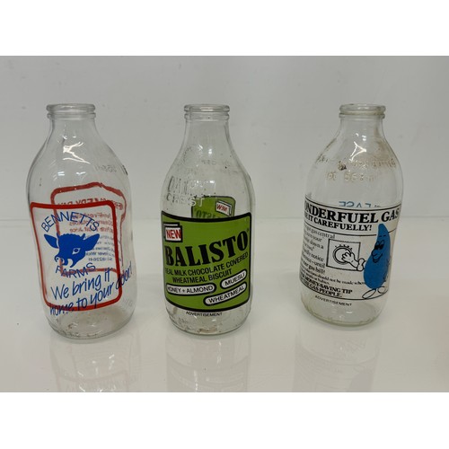 164 - A collection of advertising themed glass milk bottles.

This lot is available for in-house shipping