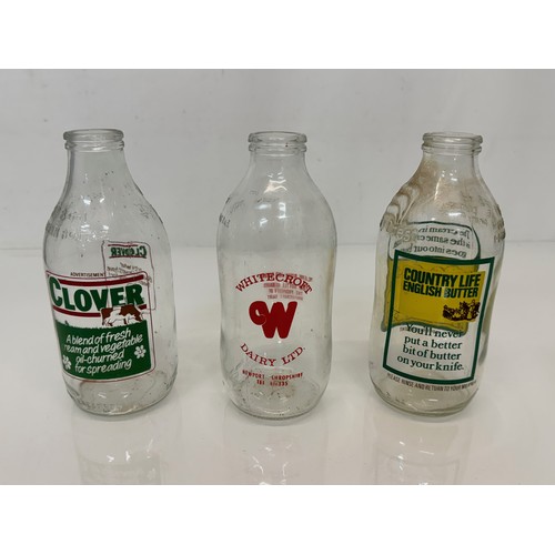 164 - A collection of advertising themed glass milk bottles.

This lot is available for in-house shipping