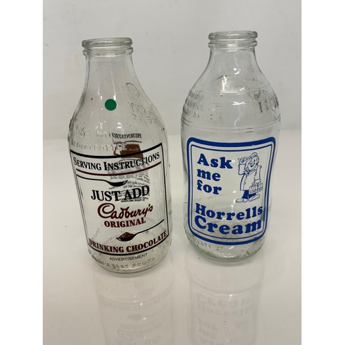 164 - A collection of advertising themed glass milk bottles.

This lot is available for in-house shipping