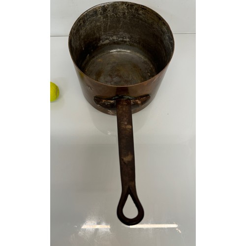 325 - Kitchenalia, a large  and very weighty copper saucepan, 28 cm in diameter x 20 cm deep and 58 cm lon... 