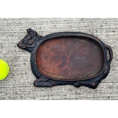 370 - Cast iron dish fitted within the centre of a seated cow form, 32 cm x 22cm 

This lot is available f... 