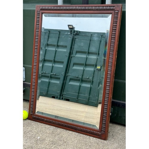 178 - Edwardian bevel edged wall mirror in a decorative wooden frame, 61 cm x 81 cm.

This lot is collecti... 