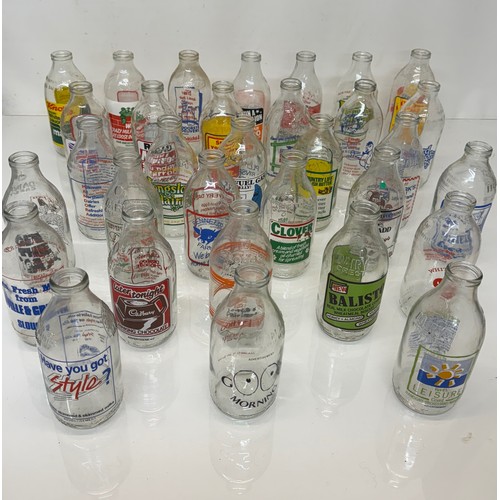 378 - A collection of advertising themed glass milk bottles.

This lot is available for in-house shipping