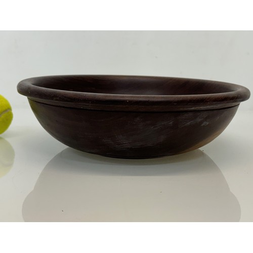 403 - A turned wooden bowl, from African hard wood, 29.5 cm diameter x 8.5 cm hogh.

This lot is available... 