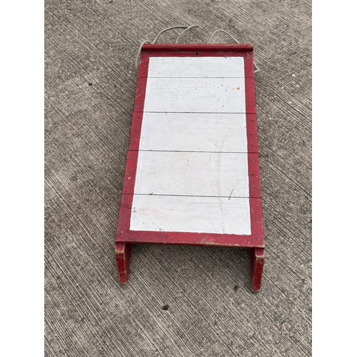 11 - Painted wooden sledge with metal runners.

This lot is available for in-house shipping